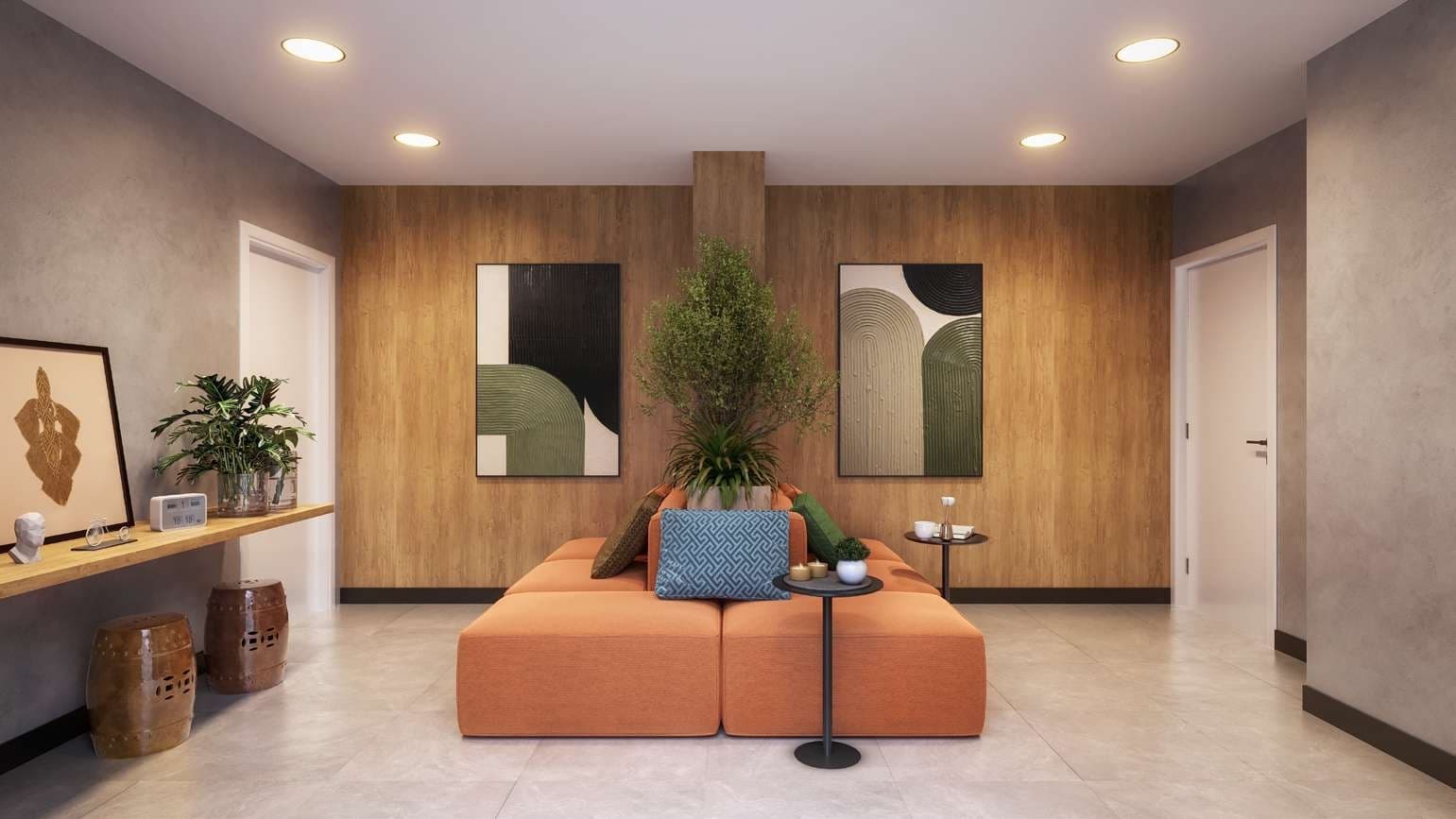 Área comum interna com sofá modular laranja, paredes revestidas em madeira e quadros decorativos.